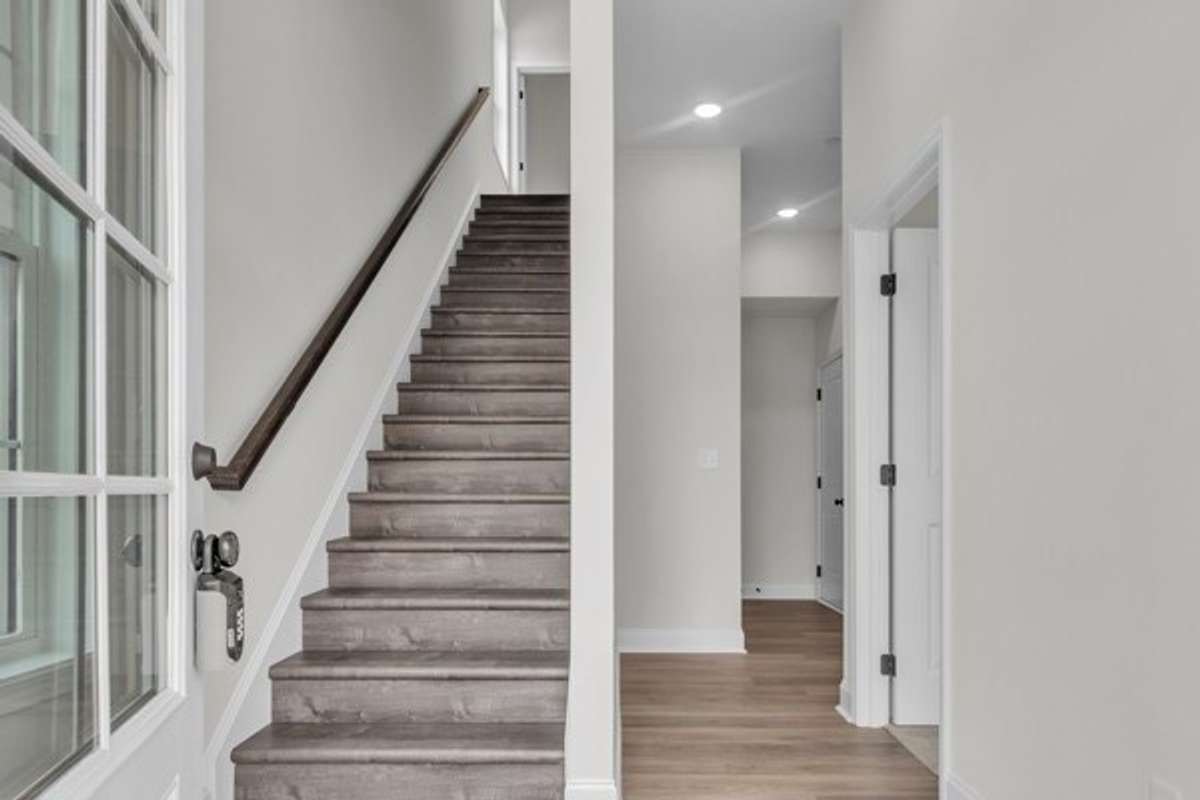 As you enter the 1st floor a private guest bedroom is on the right and then a full bath, coat closet and entrance to 2 car garage.