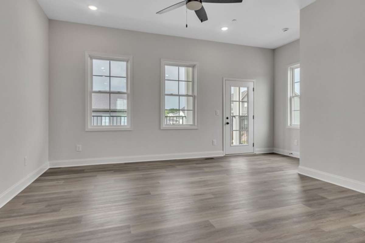 This gorgeous space is wrapped in windows and features an expansive deck on the front of home for additional entertainment space to enjoy with guests.