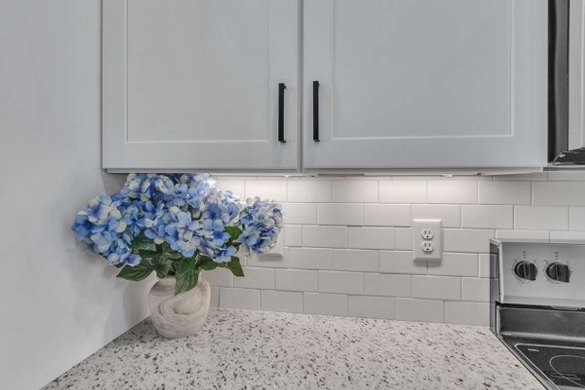 Be sure to take an extra look at the lovely granite, subway tile back splash & modern cabinetry.