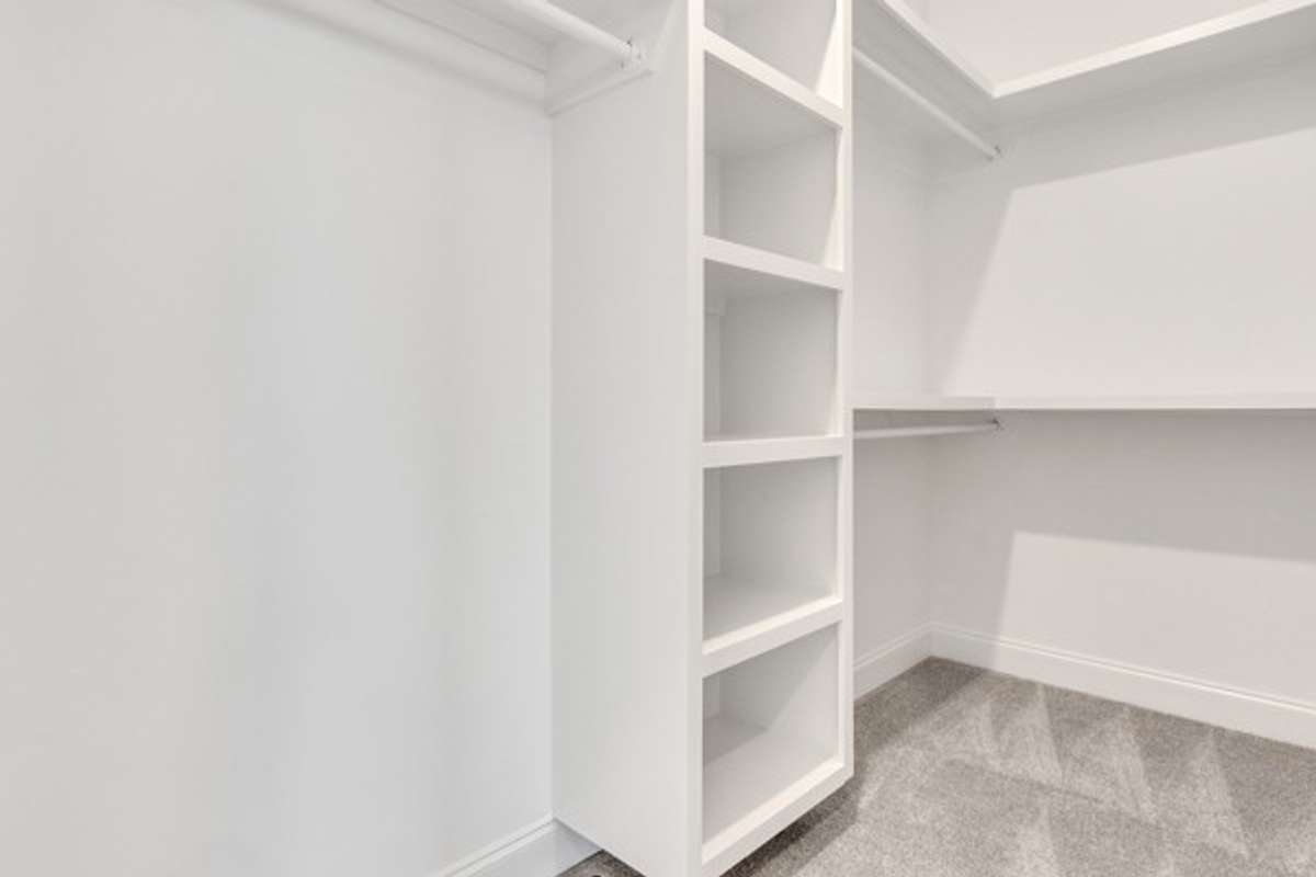 Well appointed custom closet with plenty of room for owners belongings.
