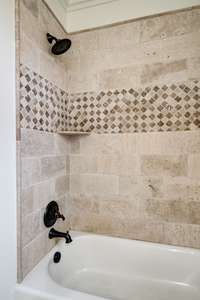 Surround tile and full bath tub in upstairs bedroom.