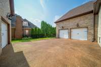Expansive driveway leads to a spacious 3-car garage, offering ample room for vehicles, storage, and weekend projects—perfect for families or car enthusiasts.