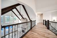 Take in the beautiful views of the wood beams as you walk across the upstairs walkway to another 3rd bedroom, hobby room and bonus room.