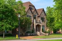 Elegant entry with timeless curb appeal and custom iron doors. Set in a prestigious neighborhood, this home blends classic design with upscale finishes and mature landscaping.