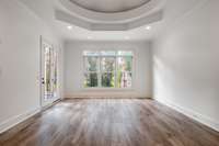 French doors and triple window provide the sunlight to bring life to the master bedroom located on the backside of the house.