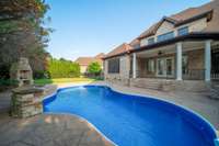 The sparkling pool boasts a brand-new liner and pumps, along with a waterfall feature that enhances both privacy and ambience.