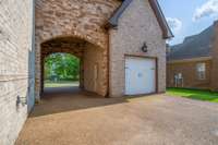 Stately porte-cochère offers a grand covered entryway or additional parking, blending elegance with practicality—perfect for welcoming guests or unloading with ease.
