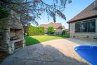 Enjoy ultimate privacy in this beautifully landscaped, tree-lined, and fully fenced backyard retreat. Featuring a sparkling pool with a brand-new liner and pumps, an outdoor stone fireplace to keep things cozy year-round.