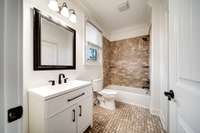 New vanity, walk-in closet and surround tile with window perfect for getting ready in natural light.