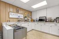 There is a kitchen space filled with cabinets and a commercial sink...make the prep and clean up work fly by