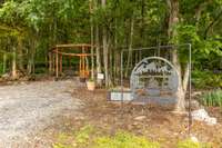 Firefly Cove is a spacious 12 person octagon swing with a firepit centerpiece and an epoxy sealed Cedar Bar