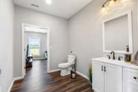 Spacious half bathroom located off the current groom room.