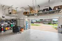 3 car garage w/epoxy floors, storm shelter & suspended storage