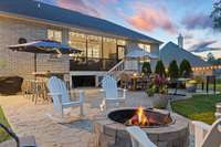Outdoor patio area w/stamped concrete, firepit, built-in stone bar.