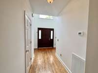 This home is freshly painted throughout!! Gorgeous hardwoods in the entry foyer with a huge window over the front door and tall ceiling for a very impressive entry!