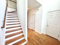 Wood treads on the stairs too! Coat closet to the right, as well as a half bath on the main floor.