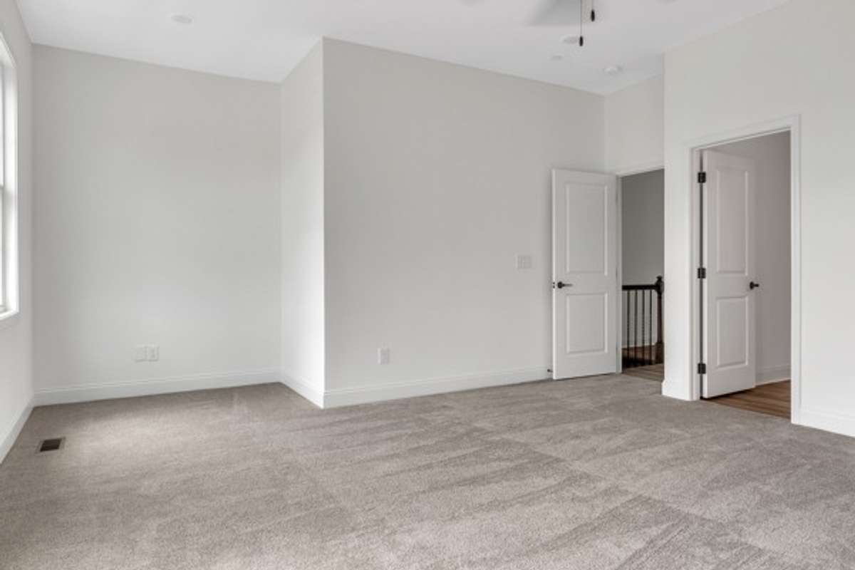 Entry into the primary suite area with the primary bath to the left of entry.