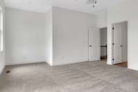 Entry into the primary suite area with the primary bath to the left of entry.