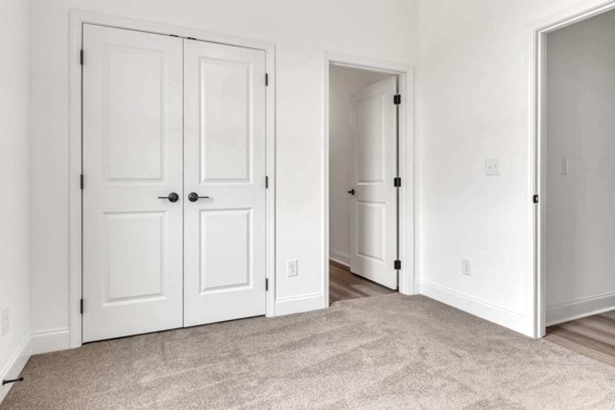 Guest bedroom closet and entry to private bathroom.