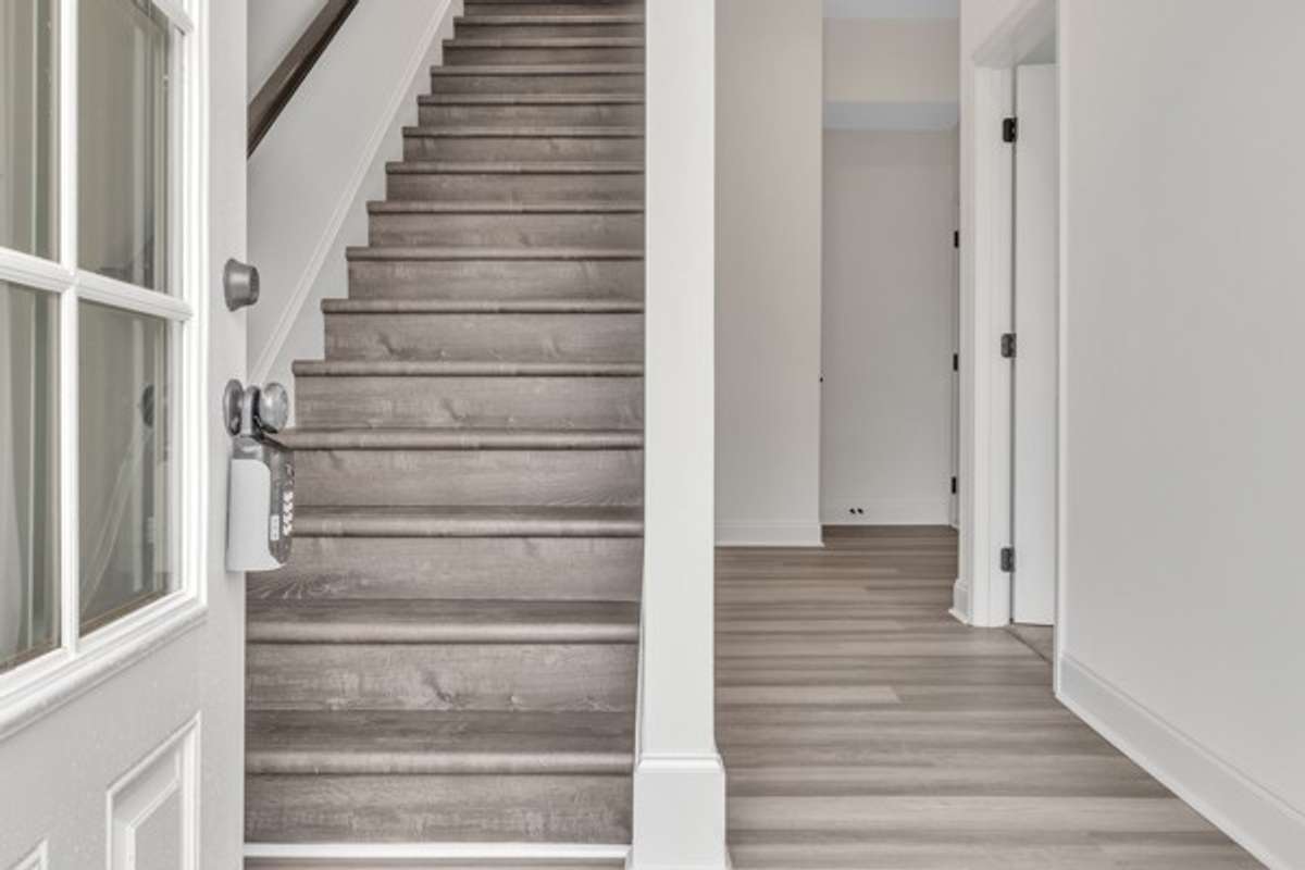 The ground floor features a private guest bedroom, a coat closet. private full bath and entry to the 2 car garage.