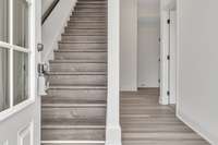 The ground floor features a private guest bedroom, a coat closet. private full bath and entry to the 2 car garage.