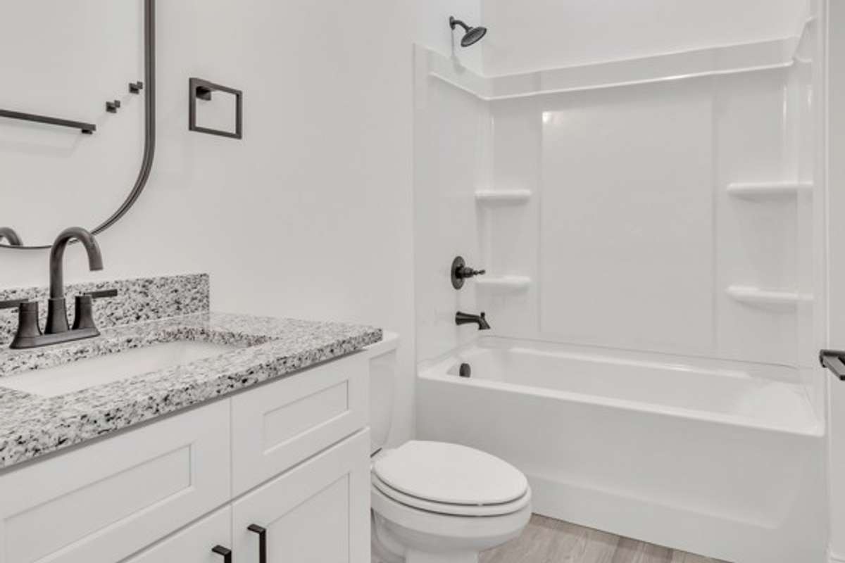 1st floor bathroom convenient to foyer and garage entry.