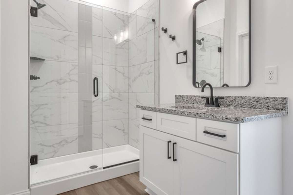 Primary bath with granite, elegant tile & 10 ft celings.
