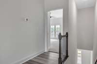 Entry to primary bedroom to the right of stairs on front side of home.