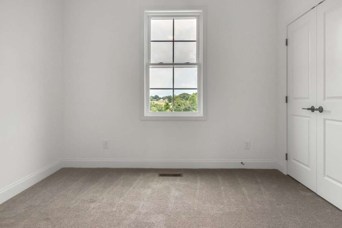 Private guest bedroom on 3rd floor with 10 ft ceilings and modern ceiling fan/lighting.