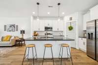So sleek... black marble pairs well with white Craftsman cabinets & black cabinet hardware!
