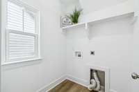 Nice utility room with built-in wooden shelf & window!