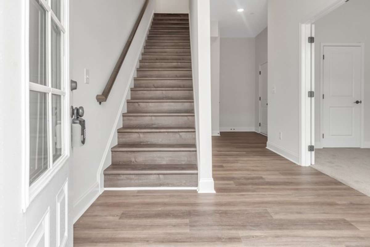 As you enter the 1st floor a private office or flex room is on the right and then a half bath, coat closet and entrance to 2 car garage.