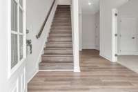 As you enter the 1st floor a private office or flex room is on the right and then a half bath, coat closet and entrance to 2 car garage.