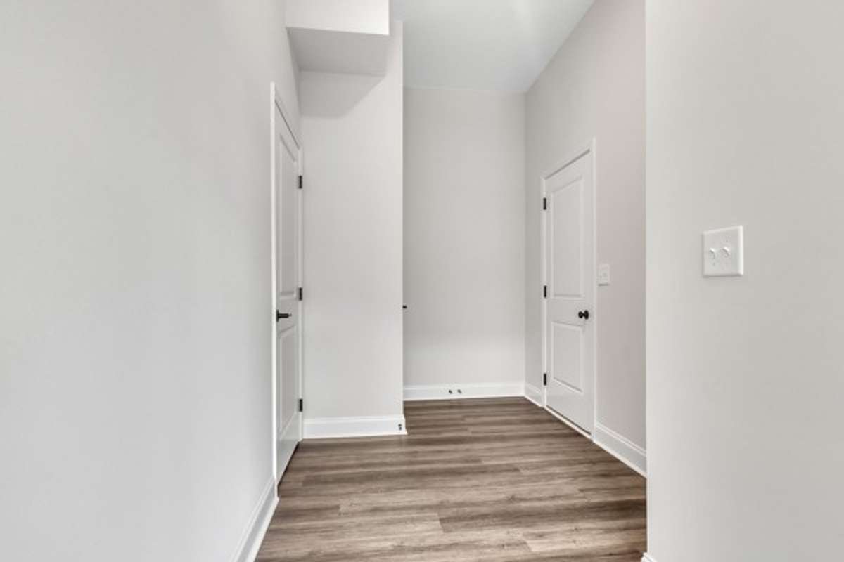Entry area from foyer to half bath and garage entryway.