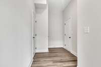 Entry area from foyer to half bath and garage entryway.