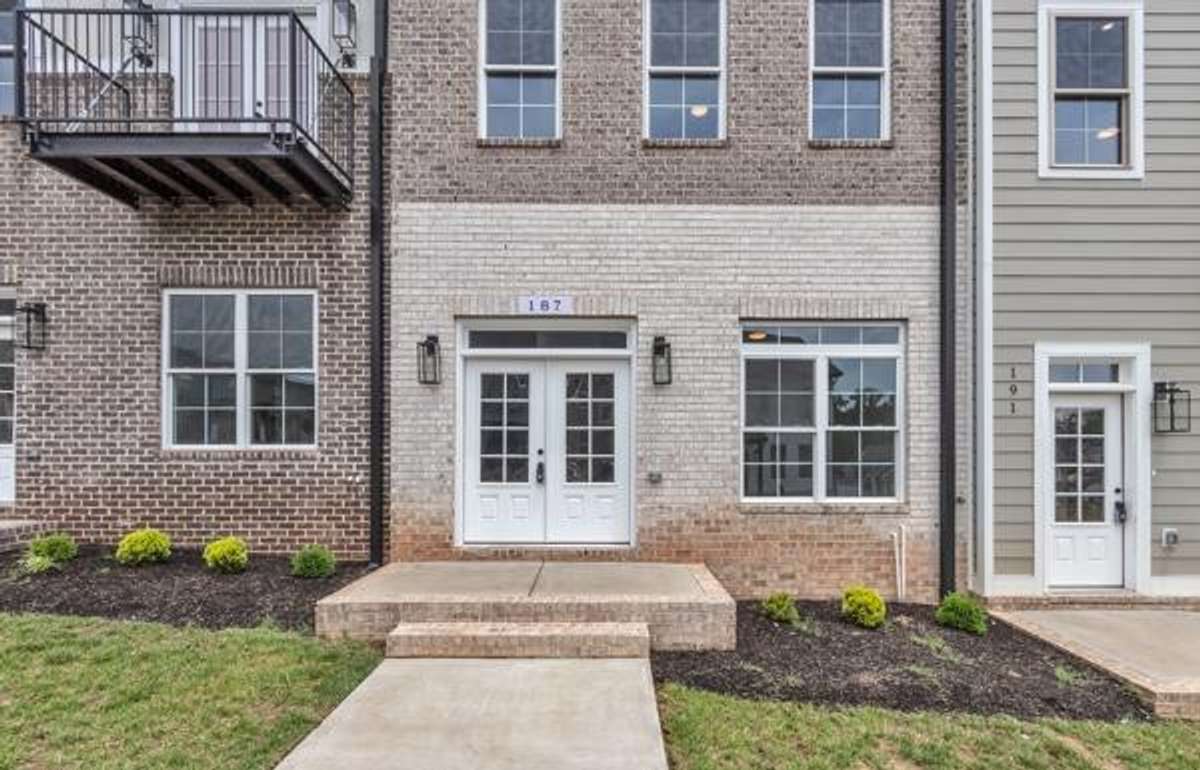 With double doors, a transom window & carriage lighting this porch is just waiting for your seasonal decor to welcome guests.