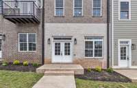 With double doors, a transom window & carriage lighting this porch is just waiting for your seasonal decor to welcome guests.
