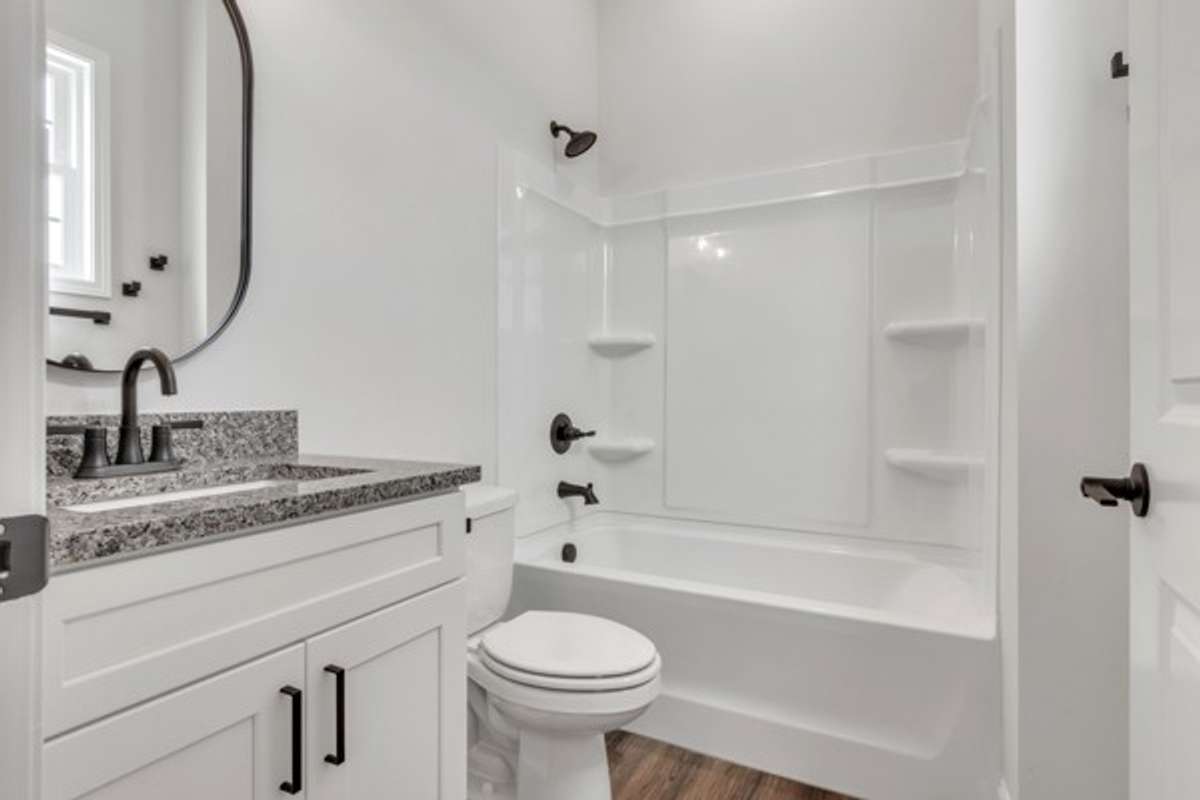 Private full bath to 2nd guest bedroom featuring granite, modern decor & fixtures highlighted by a window to make it extra bright.