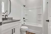 Private full bath to 2nd guest bedroom featuring granite, modern decor & fixtures highlighted by a window to make it extra bright.