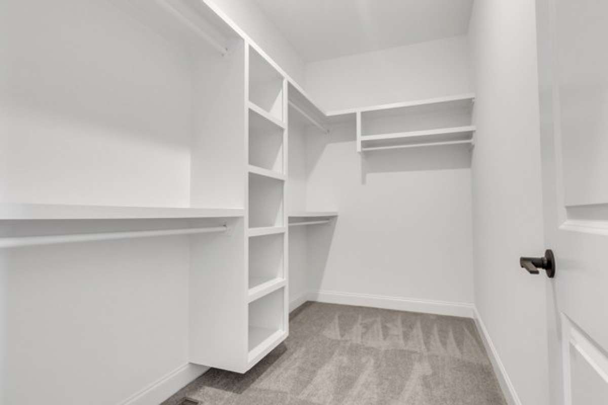 Continue the retreat feeling with a large custom closet, 10 ft ceilings and modern lighting.
