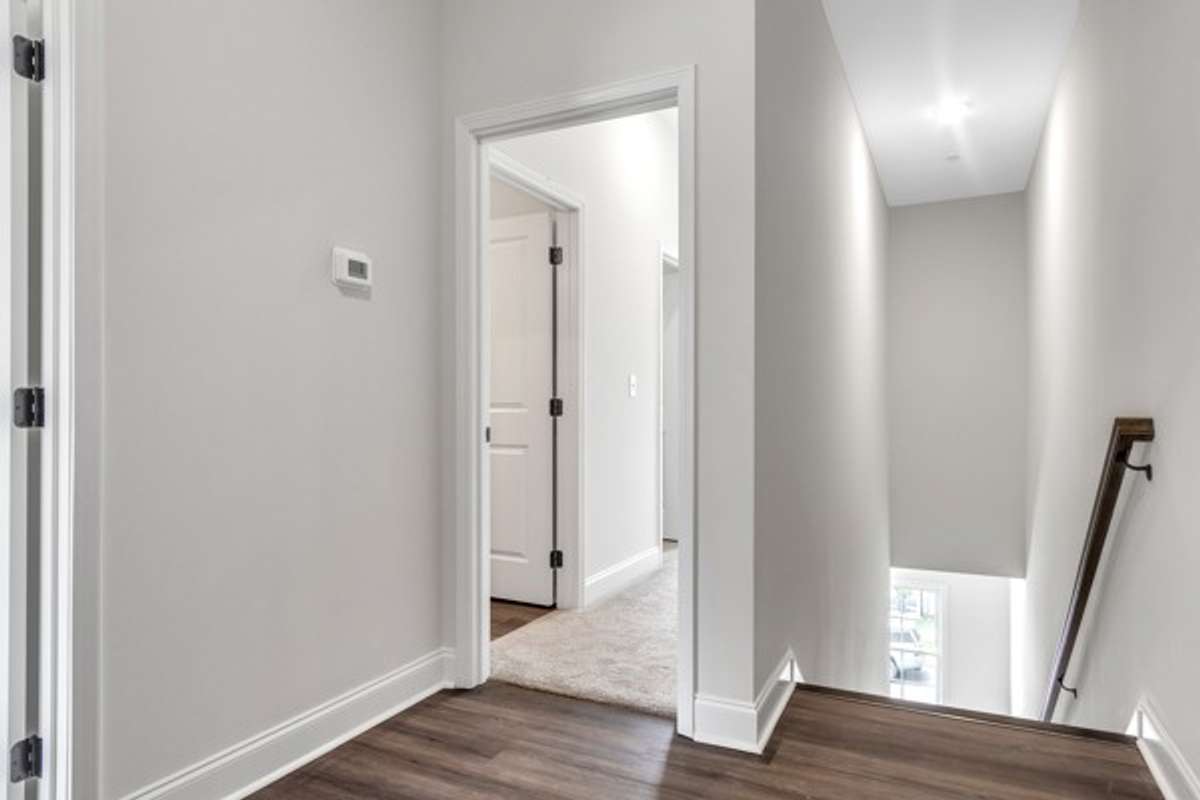 3rd floor landing with owner's retreat entry to right toward front of home.