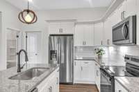 The guest bedroom is conveniently located just off the kitchen.