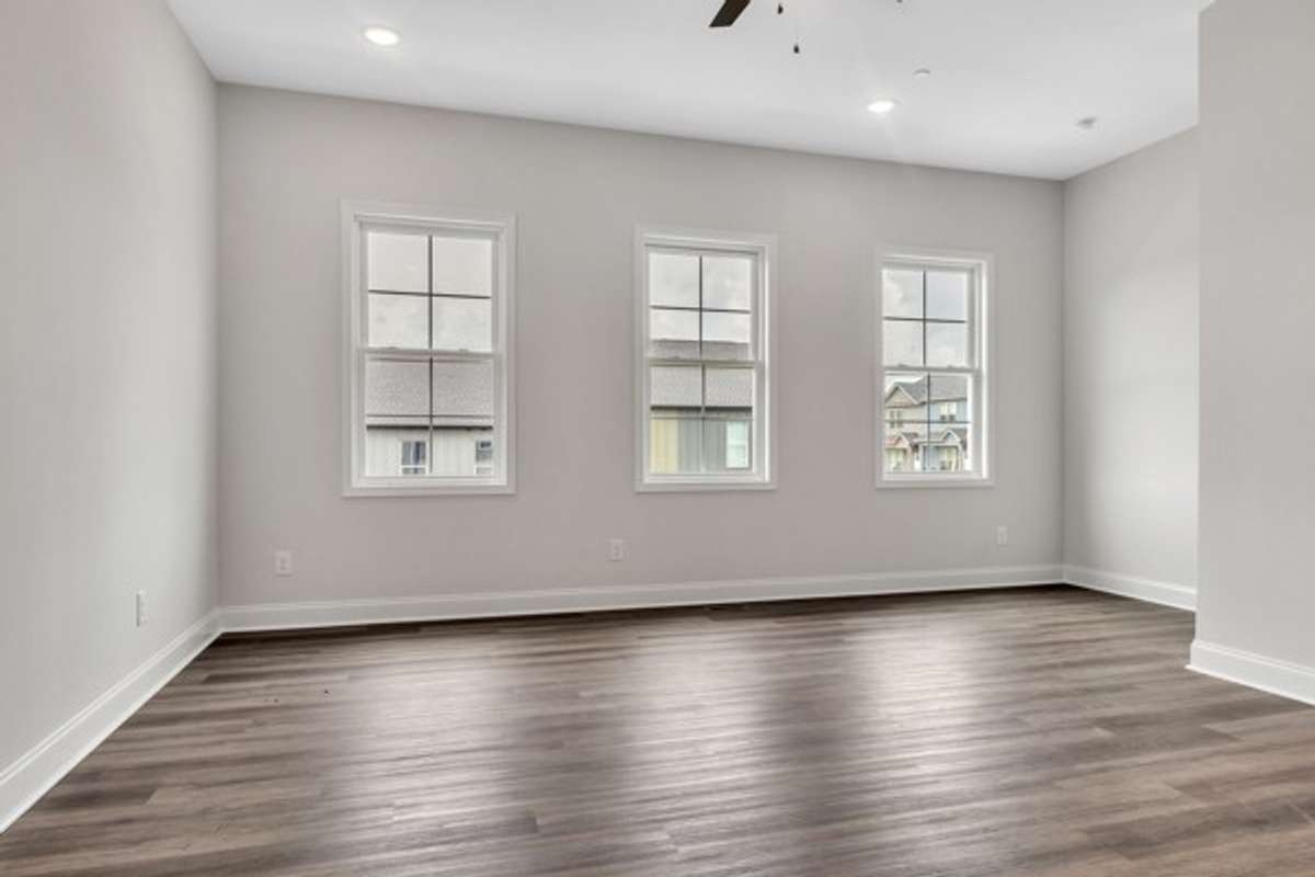 Check out the gorgeous wall of windows that fill the living area with light even without turning on the ceiling fan light and recessed lighting.