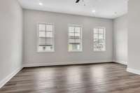 Check out the gorgeous wall of windows that fill the living area with light even without turning on the ceiling fan light and recessed lighting.