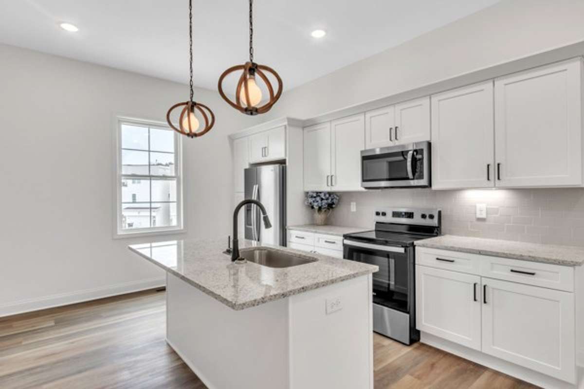 This kitchen is so bright and friendly with multiple light sources including the pendants, recessed lighting, under cabinet lighting and large window to let natural light stream in.