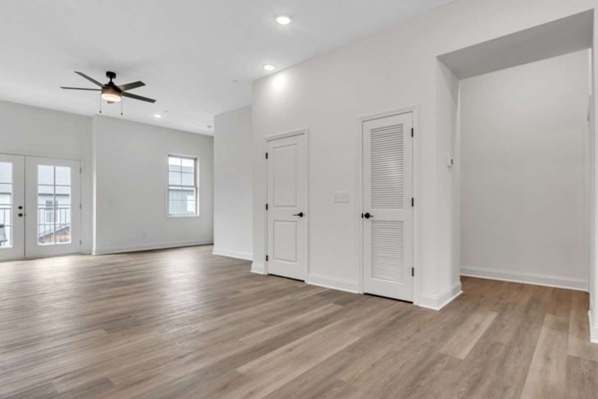 This gorgeous living space is filled with natural light and features an adorable deck on the front of home for additional entertainment space perfect for flower pots and a kitchen garden.