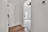 3rd floor landing with laundry area entry to left and entry to 2nd guest room.