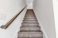 Beautiful hard wood stairs to the 3rd floor where you will find the laundry room along with the primary and 2nd guest bedrooms. (Both with private baths)