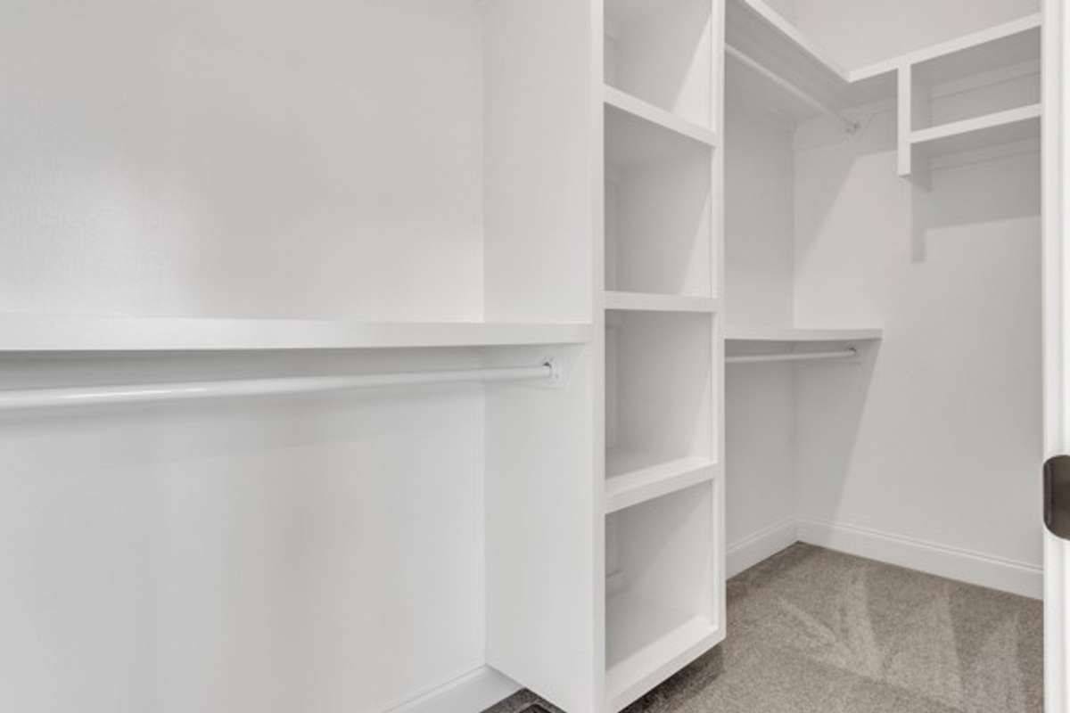 Well appointed custom closet with plenty of room for owners belongings.