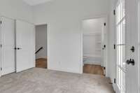 Guest bedroom toward entry door and bath.